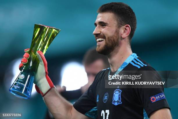 Spain's goalkeeper Unai Simon poses with the "Star of the Match" trophy during the UEFA EURO 2020 quarter-final football match between Switzerland...