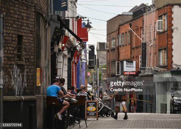 People enjoying afternoon drinks and food outside a bar / restaurant in Dublin city center. On Friday, 02 July 2021, in Dublin, Ireland.