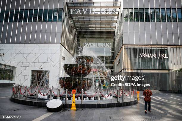 Man seen walking in front of the closed Pavilion shopping mall in downtown Kuala Lumpur. Malaysia government starts to further tighten the movement...