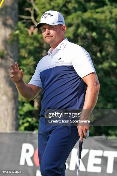 Golfer Tom Lewis reacts after making a par putt on the 9th hole on July 2, 2021 during the Rocket Mortgage Classic at the Detroit Golf Club in...