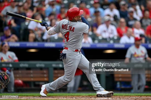 Yadier Molina of the St. Louis Cardinals follows the flight of a second inning 2-run homerun against the Colorado Rockies at Coors Field on July 2,...