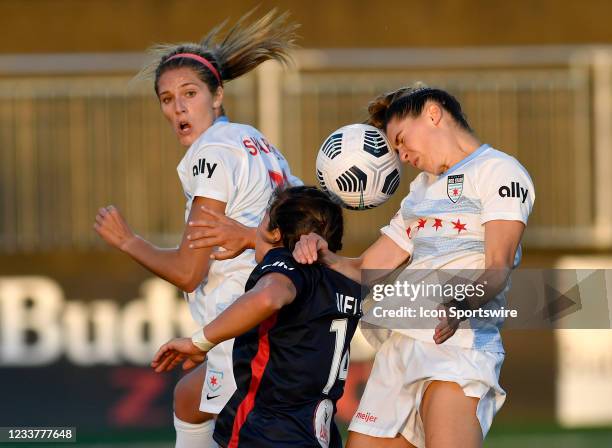 Chicagos Morgan Brian Gautrat heads a ball in the air with teammate Kayla Sharples and Washingtons Paige Neilsen during the Chicago Red Stars versus...