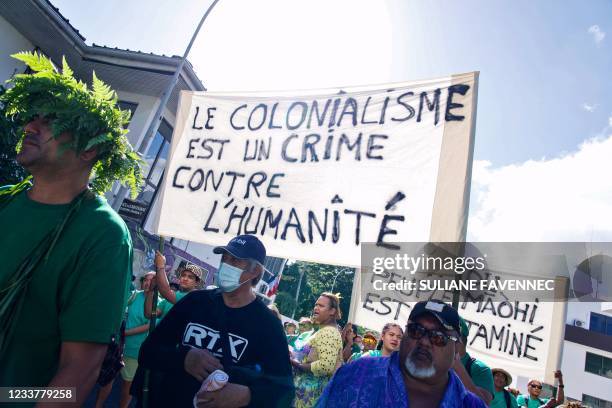 Some Polynesians amongst 2000 hold a placard reading "Colonialism is a crime against humanity " during a march called by the anti-nuclear association...