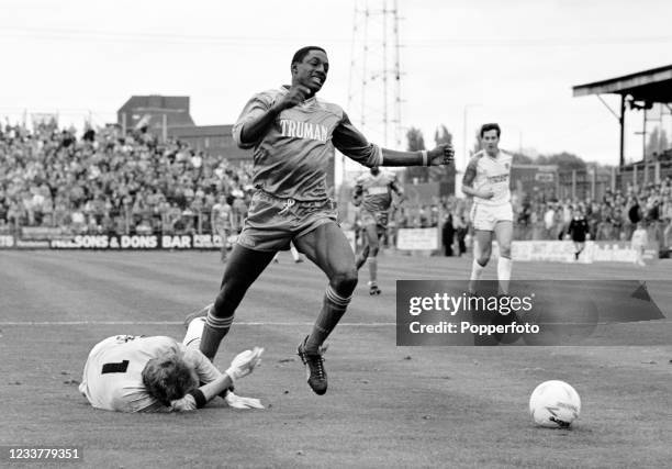 John Fashanu of Wimbledon is taken down by Norwich City goalkeeper Graham Benstead during a Today League Division One match at Plough Lane on October...