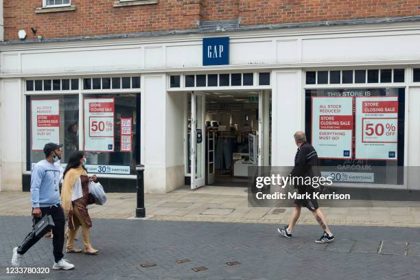 Store closing sale posters are pictured in the window of a branch of the fashion chain store Gap on 2nd July 2021 in Windsor, United Kingdom. Gap has...