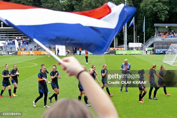 Fan waves a Dutch flag during the goodbye training of The Netherlands' national women football team in Zeist, on July 3, 2021. - The team leaves for...