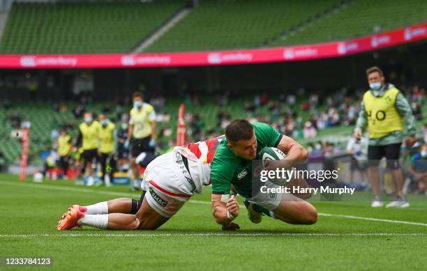 Dublin , Ireland - 3 July 2021; Jacob Stockdale of Ireland dives over to score his side's fifth try despite the tackle of Semisi Masirewa of Japan...