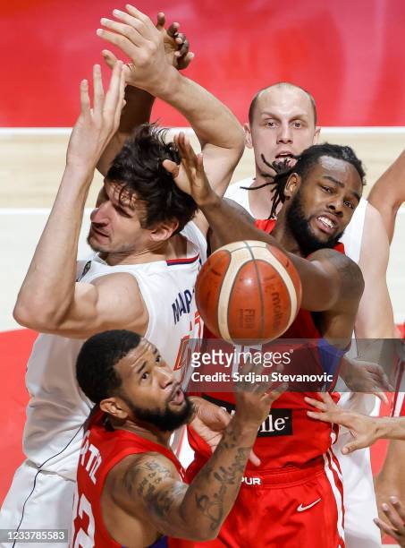 Timajh Dyquan Parker Rivera of Puerto Rico jump for the ball against Boban Marjanovic of Serbia during the FIBA Basketball Olympic Qualifying...