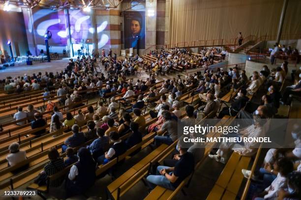 Believers sit in the St Bernadette's church listening to the recital based on the musical "Bernadette of Lourdes, as the Catholic sanctuary of Notre...