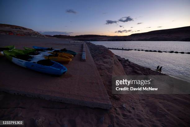 Kayakers come ashore at the end of the day at the Antelope Point boat launch ramp which was made unusable by record low water levels at Lake Powell...