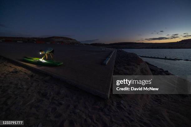 Kayaker comes ashore at the end of the day at the Antelope Point boat launch ramp which was made unusable by record low water levels at Lake Powell...