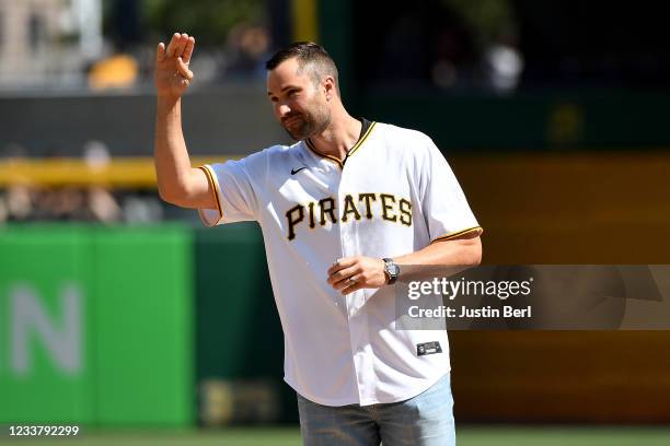 Former Pittsburgh Pirates player Neil Walker waves to the crowd before throwing out the first pitch before the game between the Pittsburgh Pirates...