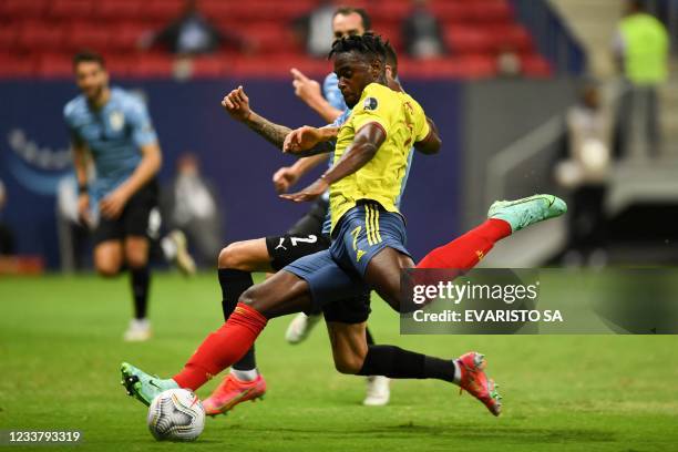 Colombia's Duvan Zapata and Uruguay's Jose Maria Gimenez vie for the ball during their Conmebol 2021 Copa America football tournament quarter-final...