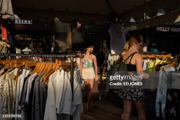 Shoppers browse garments at a clothes stall on Church street in Burlington, Vermont on June 28, 2021. - Vermont -- known for Bernie Sanders, the...