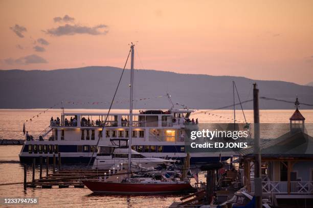 Ferry carries passengers into a harbor of Lake Champlain in Burlington, Vermont on June 28, 2021. - Vermont -- known for Bernie Sanders, the first...