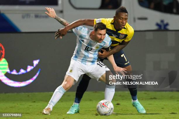 Argentina's Lionel Messi and Ecuador's Pervis Estupinan vie for the ball during their Conmebol 2021 Copa America football tournament quarter-final...