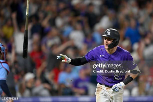 Trevor Story of the Colorado Rockies tosses his bat after hitting a seventh inning three-run homerun against the St. Louis Cardinals during a game at...