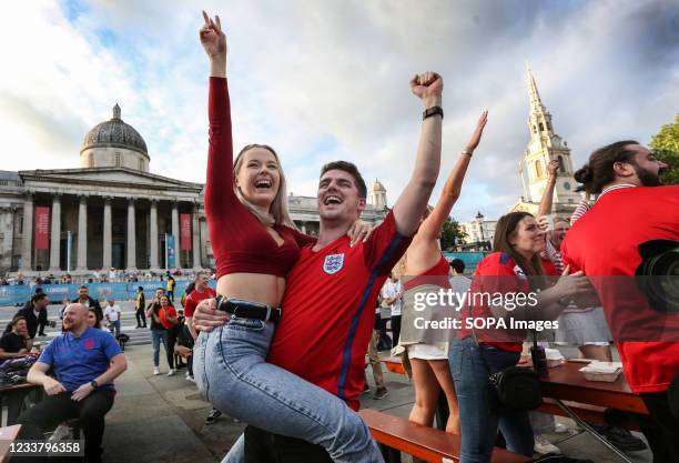 Fans celebrate Harry Kane's first goal as England fans watch the euro 2020 quarter final match between England and Ukraine from inside the Fan Zone...