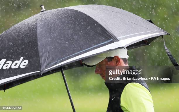 Rory McIlroy makes his way down the 10th fairway as rain starts to fall during day four of the Dubai Duty Free Irish Open at Mount Juliet Estate golf...