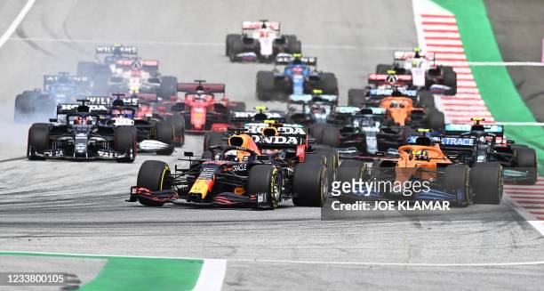 Red Bull's Dutch driver Max Verstappen leads the pack as drivers take the start of the Formula One Austrian Grand Prix at the Red Bull Ring race...