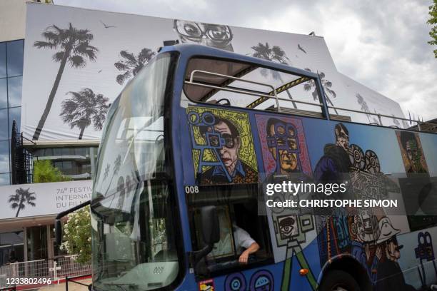 Tourist bus rides past the Palais des Festivals et des Congres in Cannes, Southeastern France, on July 4 two days before the start of the 74th Cannes...
