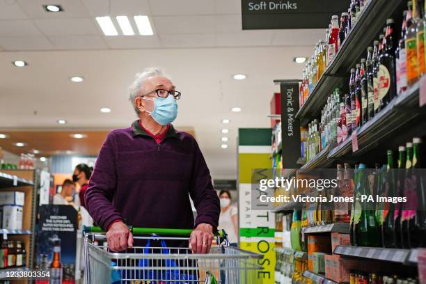 Shopper wearing a facemask in a supermarket in East London, during the easing of lockdown restrictions in England. Picture date: Sunday July 4, 2021.