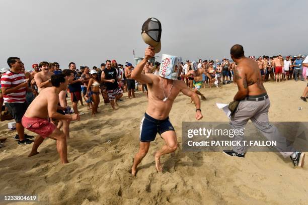 Participants collide with one another in a mosh pit during a punk rock Neckbreaker Band performance following the 47th annual Hermosa Beach Ironman...
