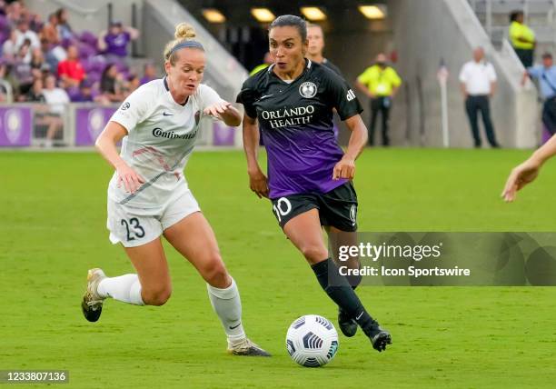 Orlando Pride forward Marta looks to pass the ball as North Carolina Courage forward Kristen Hamilton defends during the NWSL soccer match between...