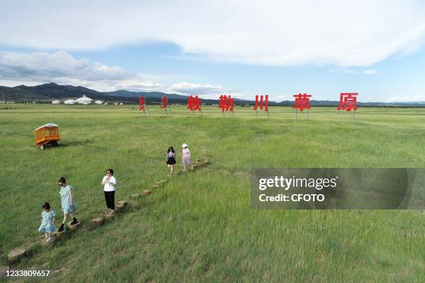 Tourists visit the Chilechuan National Grassland Natural Park in Hohhot, Inner Mongolia, China, July 4, 2021.