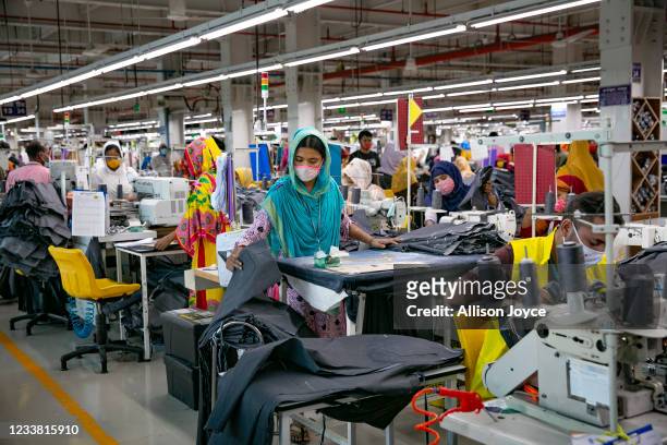 Garment workers work at a factory during a countrywide lockdown to try to contain the spread of Covid-19 on July 5, 2021 in Dhaka, Bangladesh....