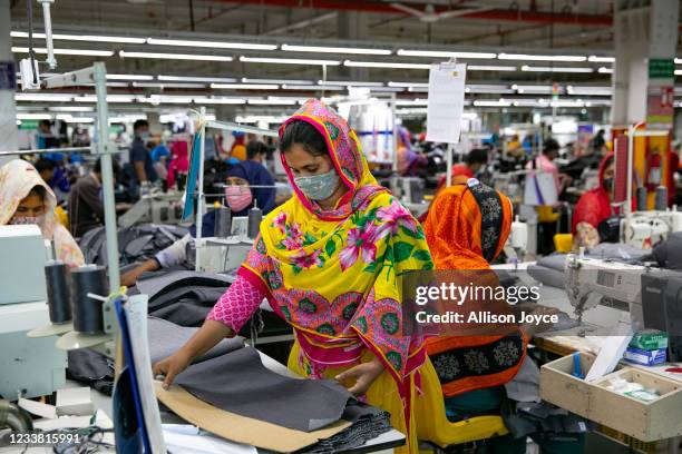 Garment workers work at a factory during a countrywide lockdown to try to contain the spread of Covid-19 on July 5, 2021 in Dhaka, Bangladesh....