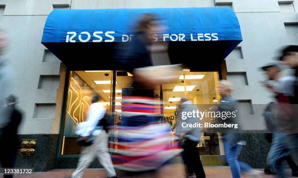 Pedestrians pass in front of a Ross Stores Inc. Location in San Francisco, California, U.S., on Wednesday, Aug. 31, 2011. Ross Stores Inc. Is gaining...