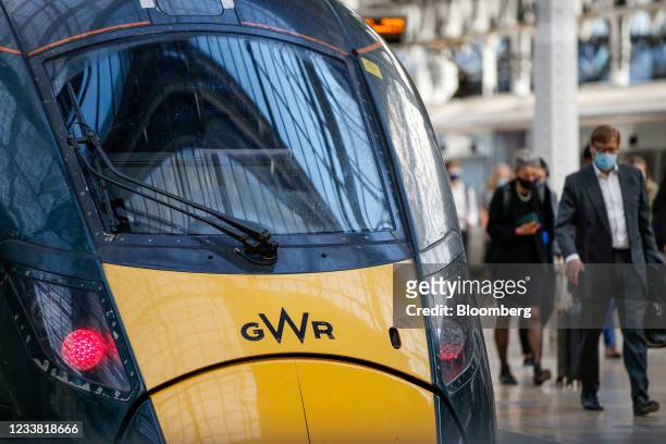 Commuters disembark from a Great Western Railway train, operated by FirstGroup Plc, at London Paddington railway station in London, U.K., on Monday,...