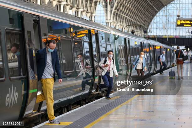 Commuters disembark a Great Western Railway train, operated by FirstGroup Plc, at London Paddington railway station in London, U.K., on Monday, July...
