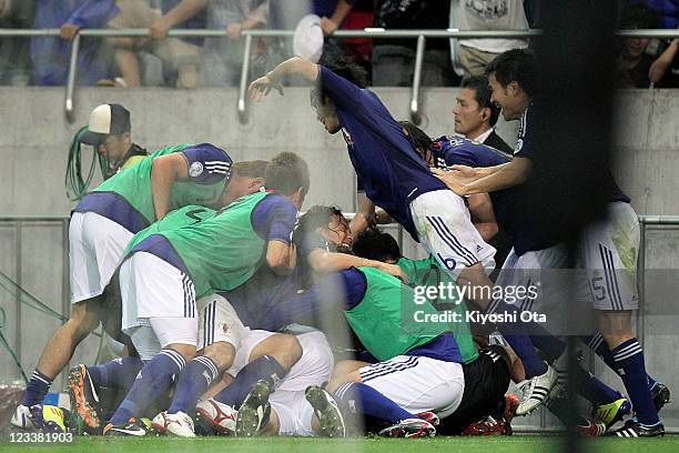 Japan team players celebrate a goal scored by Maya Yoshida of Japan against North Korea during the 2014 FIFA World Cup Brazil Asian 3rd Qualifier...