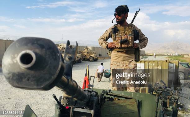 An Afghan National Army stands on a Humvee tank who keeps watch after the US forces left Bagram airfield in the north of Kabul, Afghanistan, on July...