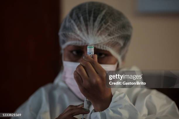 Nurse wearing PPE prepares a dose of Sinopharm vaccine as part of a campaign to bring awareness to vaccination against COVID-19 on July 5, 2021 in La...
