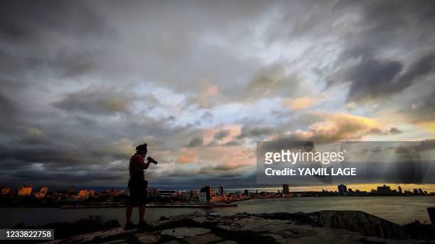 Photographer takes pictures of the sunset before the passage of Tropical Storm Elsa in Havana, on July 5, 2021.