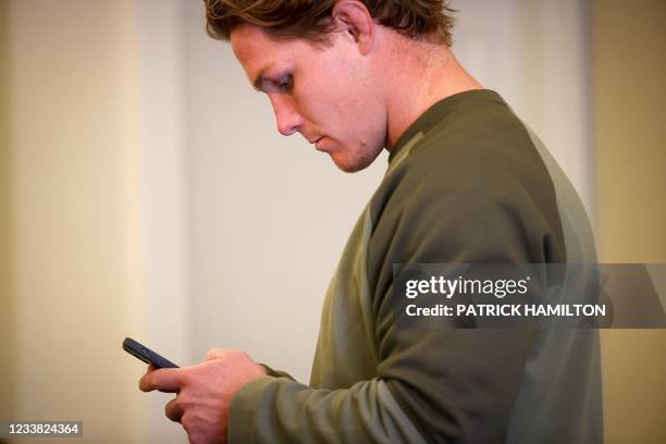 Australia's rugby team captain Michael Hooper checks his messages after a press conference at Sanctuary Cove in Gold Coast on July 06 ahead of the...