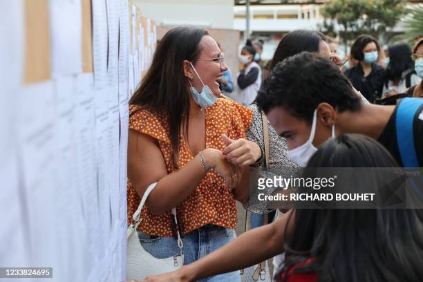 Student react as they check the results of the baccalaureat exam at a high school in Saint-Denis de la Reunion, on the French island of Reunion in...