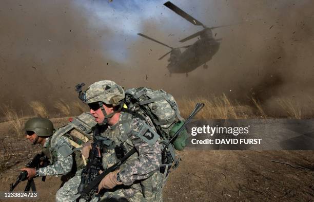 In this file photo taken on November 11 2009, US Army soldiers from 2-506 Infantry 101st Airborne Division and Afghan National Army soldiers race to...