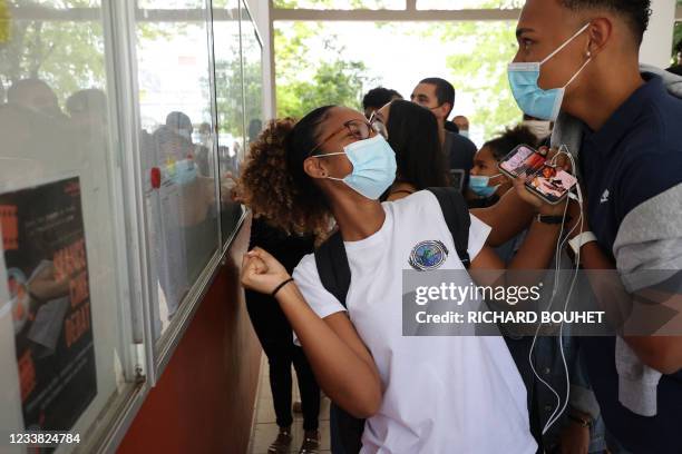 Student react as they check the results of the baccalaureat exam at a high school in Saint-Denis de la Reunion, on the French island of Reunion in...