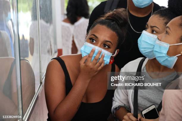 Students check the results of the baccalaureat exam at a high school in Saint-Denis de la Reunion, on the French island of Reunion in the Indian...