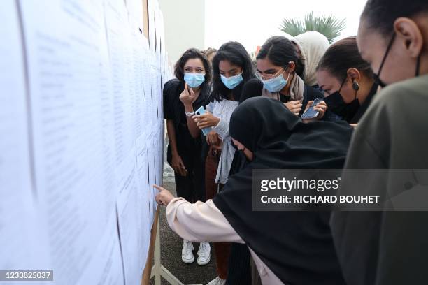 Student check the results of the baccalaureat exam at a high school in Saint-Denis de la Reunion, on the French island of Reunion in the Indian...