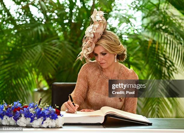 Queen Maxima of the Netherlands signs the Golden Book during a meeting with President of the Bundestag Wolfgang Schaeuble at Reichstag on July 6,...