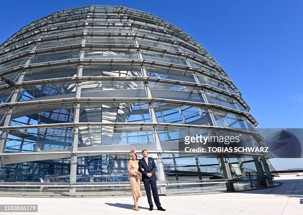 King Willem-Alexander and Queen Maxima of the Netherlands pose outside the cupola of the Reichstag building, housing the Bundestag, the lower house...