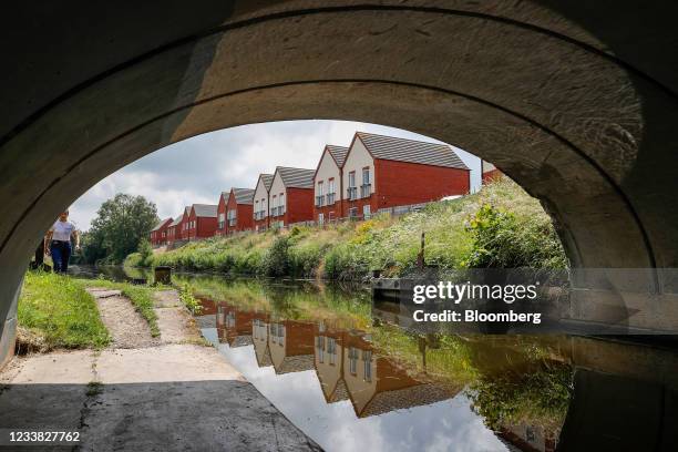 Homes on a new housing development reflected in the Grand Union Canal in Loughborough, U.K., on Saturday, July 3, 2021. Global valuations in the...