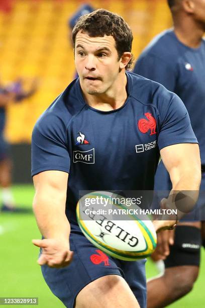 France's Anthony Etrillard passes the ball during a training session at the Suncorp Stadium in Brisbane on July 6 ahead of the first rugby union Test...