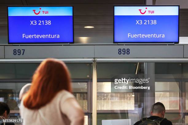 Travelers queue for a flight to Fuerteventura on Spain's Canary Islands, at the TUI AG flight check-in desks at Frankfurt Airport in Frankfurt,...