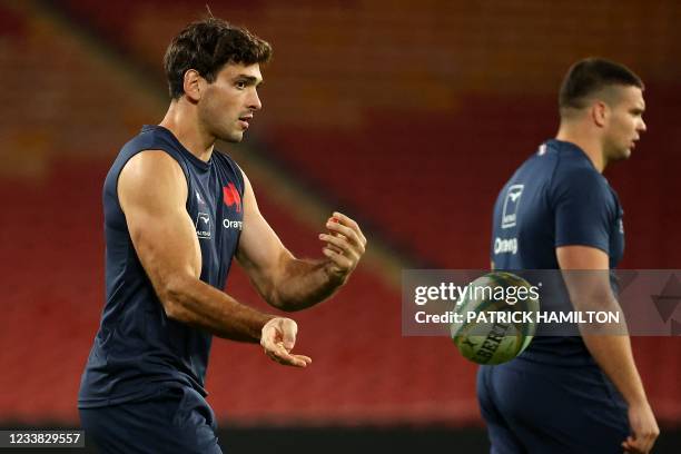 France's Julien Heriteau passes the ball during a training session at the Suncorp Stadium in Brisbane on July 6 ahead of the first rugby union Test...